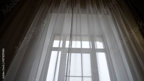 Slika na platnu Sheer white curtains covering window diffusing morning light