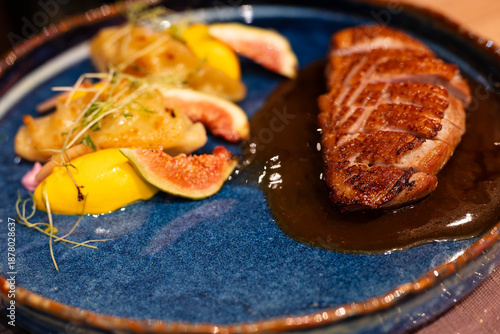 elegant hearty dinner - sauteed duck breast steak served with boiled potatoes, figs and gravy
