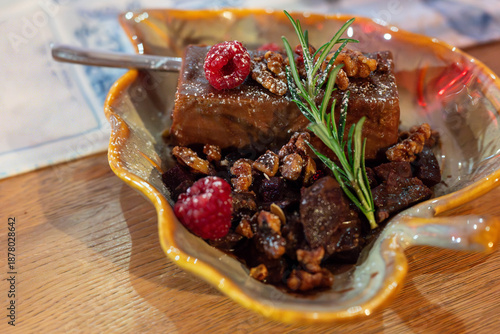 a rich and delicious winter dessert- chocolate cheesecake with brown dark sauce and walnuts