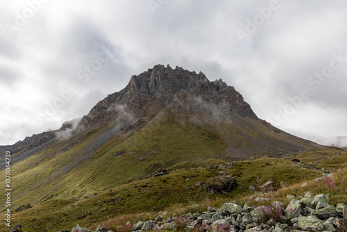 High-altitude mountain scenery at Col du Galibier in the French Alps, featuring rocky peaks beneath an overcast sky