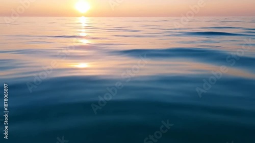 Ocean surface at sunset reflecting golden light peaceful water ripples