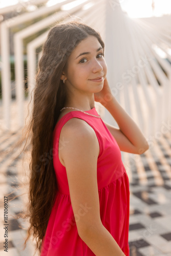 beautiful teenage brunette girl with long hair, smiling, looking at the camera during a summer walk Free Download beautiful teenage brunette girl with long hair, smiling, looking at the camera during a summer walk - GFXLoad