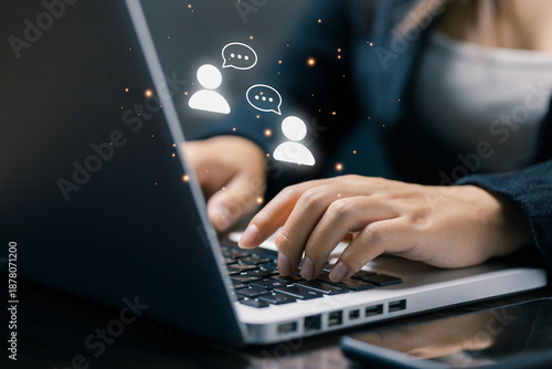 Business professional using laptop with chat icons, representing online conversation, customer interaction, digital communication, support service, and real-time messaging experience.