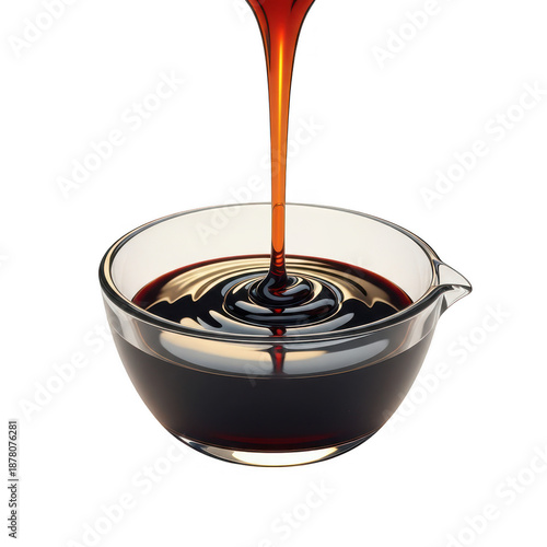 Dark syrup pouring into glass bowl isolated on transparent background