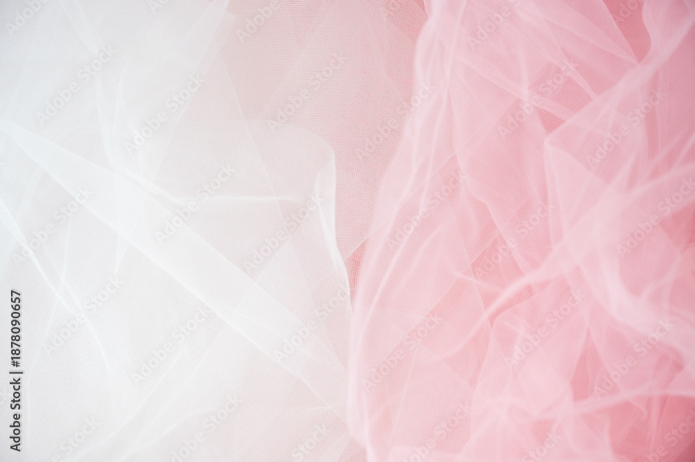 Obraz premium Abstract background of soft white and pink tulle fabric. Delicate mesh texture for wedding, bridal, or romantic feminine designs