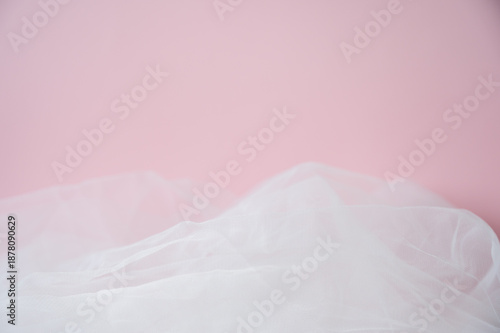 Soft pink background with ethereal tulle fabric texture. Abstract romantic backdrop with copy space for Valentine's Day, wedding, or beauty products