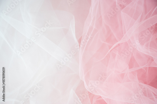 Abstract background of soft white and pink tulle fabric. Delicate mesh texture for wedding, bridal, or romantic feminine designs