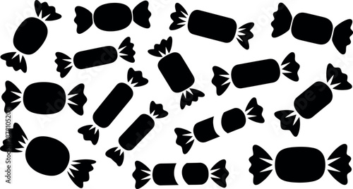 Collection of assorted black candy wrappers scattered across a clean white background in a fun pattern