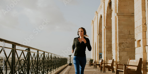 Woman runs along a path in ...