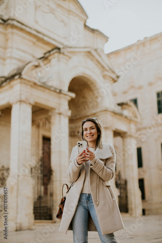 Woman walks and uses phone ...