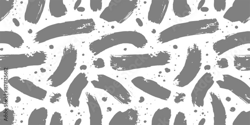 Seamless pattern with black ink splashes and brush strokes featuring vector footprints of baby feet silhouettes in a walking trace art design