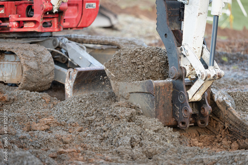 excavator scooping engineered fill with bucket