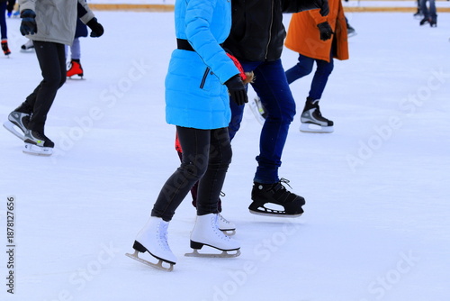 People ice skating at a rink in winter. A man and a woman skating. Sports clubs, active family recreation, winter