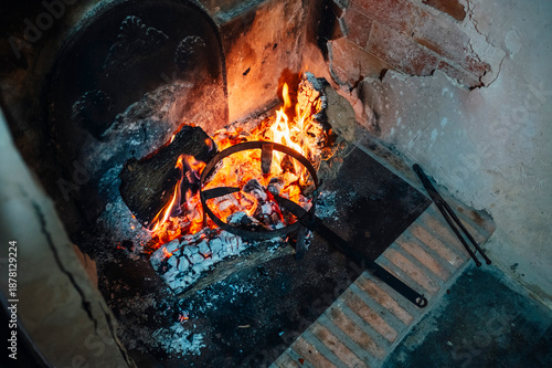 Rustic fireplace with glowing embers and coals