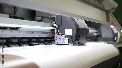 The process of printing a large-format printer in the production workshop of the printing house. Production of printing products