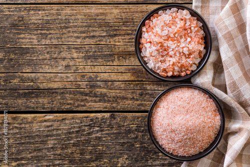 Pink Himalayan salt in bowl on wooden table. Top view. © Jiri Hera