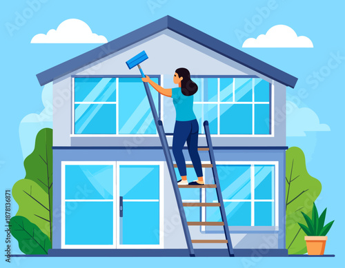 A woman stands on a ladder, diligently cleaning the large windows of a modern two-story house. This illustrates home maintenance, professional cleaning services, and taking pride in one's property.
