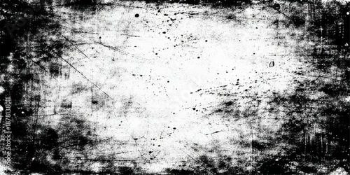 A vintage aged concrete wall features a rough dirty texture and grungy paint patterns on a gray weathered surface to create an old abstract grunge background