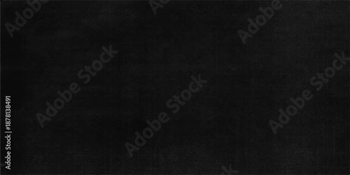 A dark grunge texture of an old black chalkboard surface provides a rough vintage wallpaper backdrop with a blank gray material pattern for artistic design