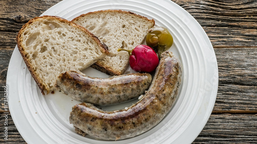Liver sausage served with bread and pickled vegetables on a plate