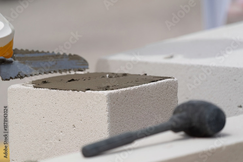 The bricklayer is working. Building a wall of aerated concrete. Gasbeton wall