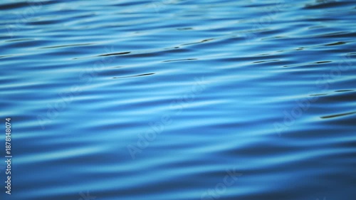 Soft water motion on blue surface, relaxing wellness and mindfulness background, 4K slow motion