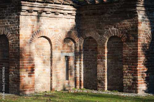 Mausoleum of Galla Placidia in Ravenna, Italy. Detail of the ancient brick exterior featuring Romanesque-Byzantine blind arches and a narrow window.