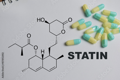 Concept of chemical structure statin write on book isolated on Wooden Table. © syahrir