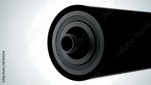 Oil A close-up view of a black cylindrical object with a circular hole on a white background