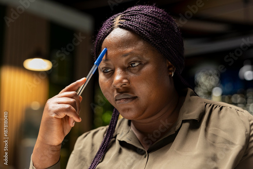 Fotografija General manager engages in methodical planning after hours at the corporate office, envisioning ideas and reflecting on business outlooks to turn a challenging problem into a tactical solution
