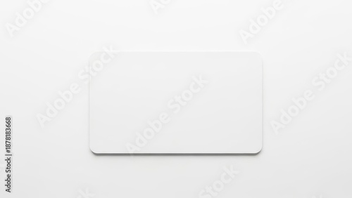 Blank white business card on white background in clean bright lighting for corporate branding.
