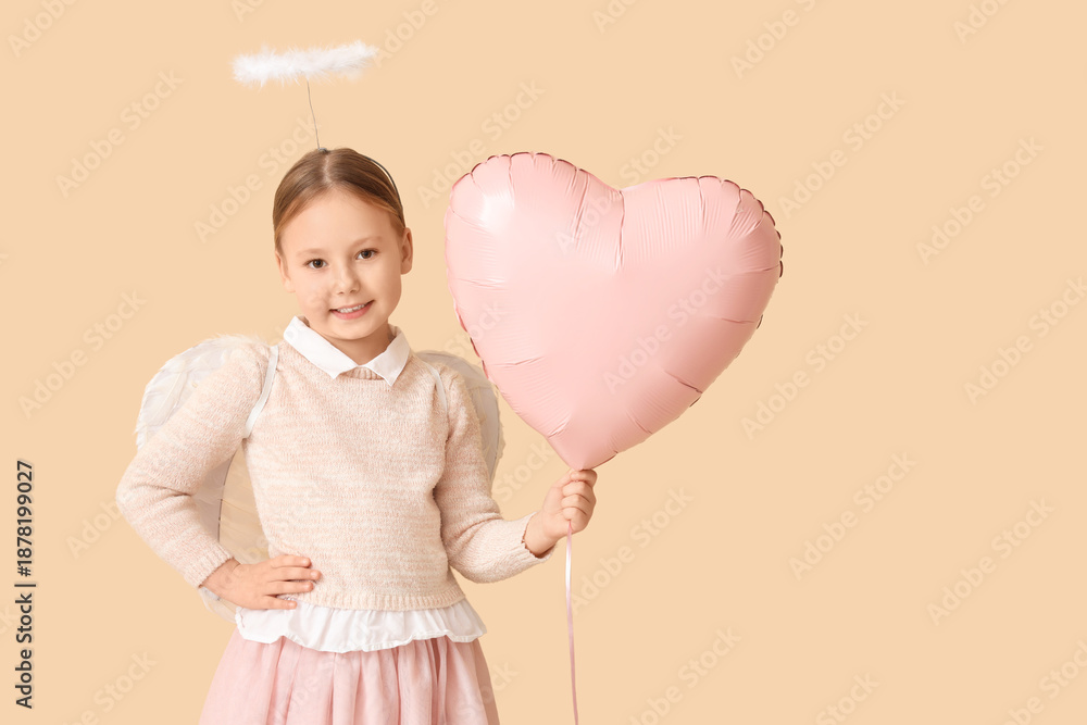 Fototapeta premium Cute little girl dressed as cupid with air balloon in shape of heart on beige background. Valentine's Day celebration