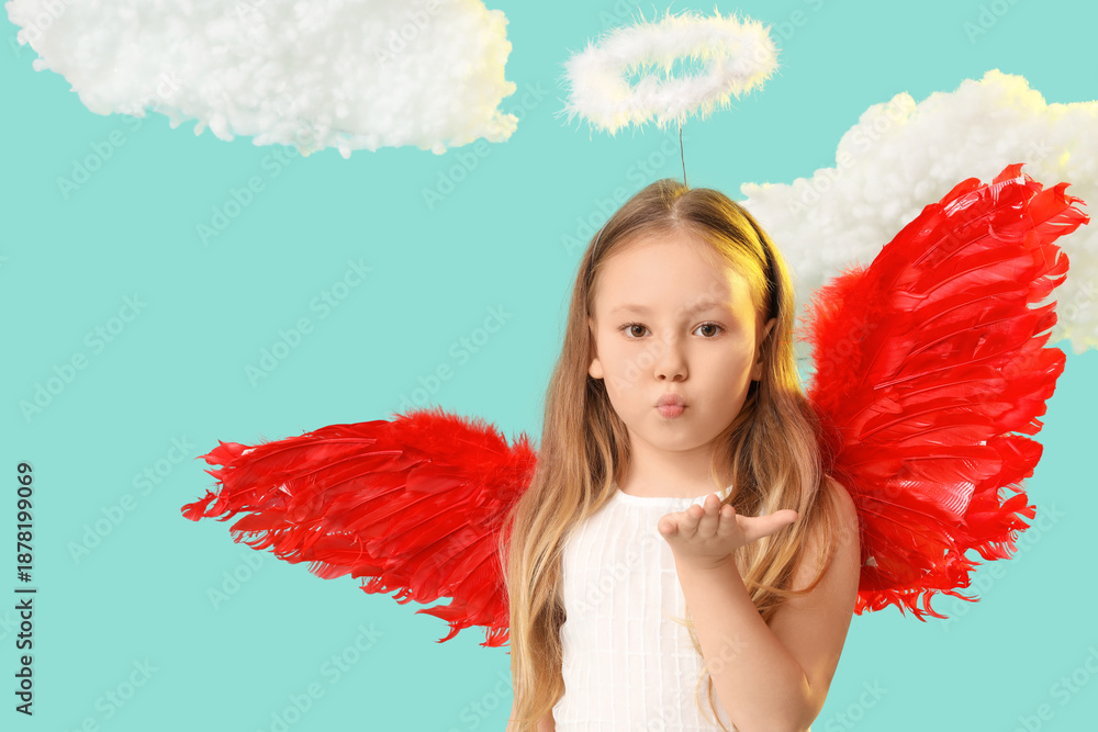 Obraz premium Cute little girl dressed as cupid blowing kiss near clouds on blue background. Valentine's Day celebration