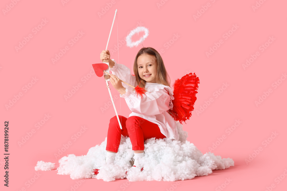 Obraz premium Cute little girl dressed as cupid with bow and arrow sitting on cloud against pink background. Valentine's Day celebration