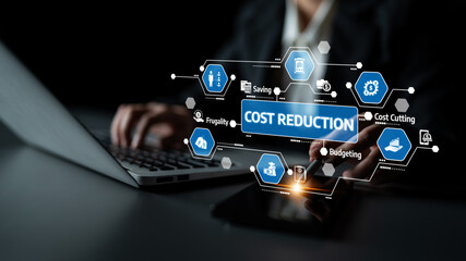 A business professional focuses on cost reduction using a laptop and mobile device, with glowing icons representing budgeting and saving strategies to enhance productivity. Tessel