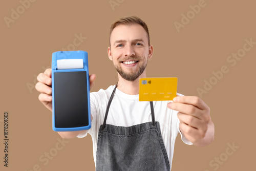 Male barista with payment t...