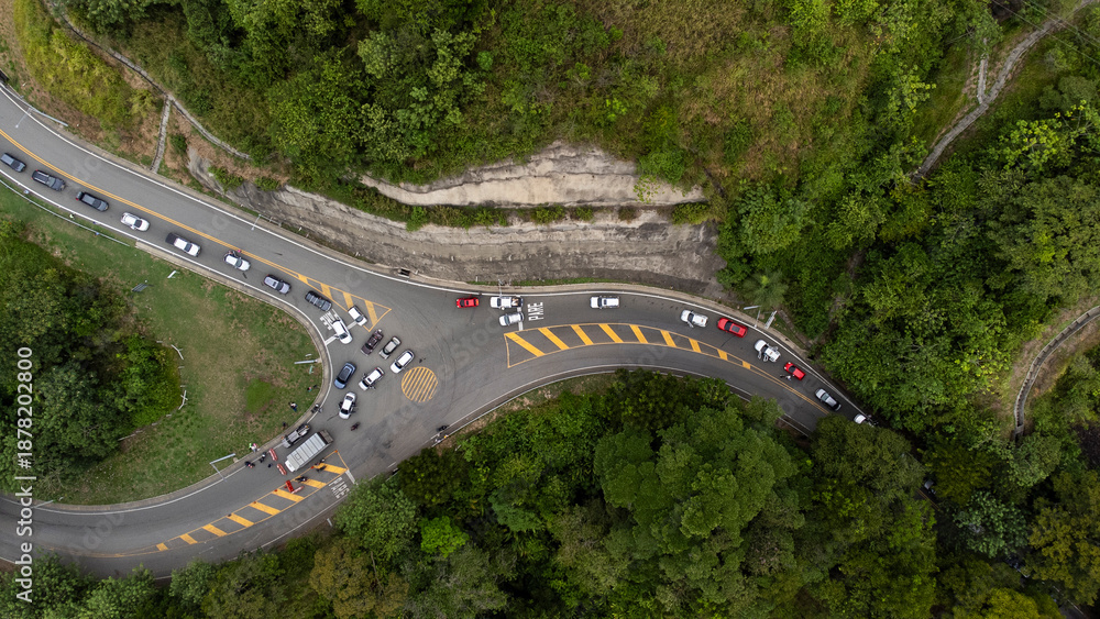 Fototapeta premium Sinifana, Antioquia - Colombia. October 8, 2025. Winding road in the Sinifaná road corridor, surrounded by green mountains