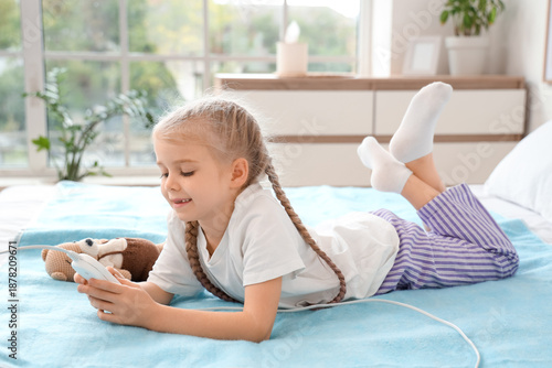 Little girl lying on electr...