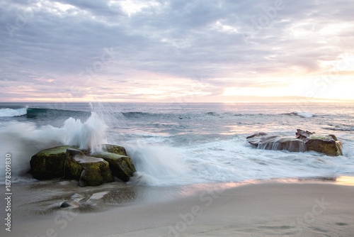 Bild auf Leinwand Cloudy evening sunset over La Jolla Califonia as waves crash upon rocks along th