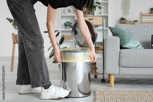 Woman putting garbage bag i...