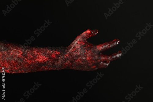 Картината върху платно Hand of zombie on black background. Halloween celebration