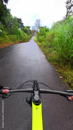 POV vertical shot of a man cycling and exercising on a road bike