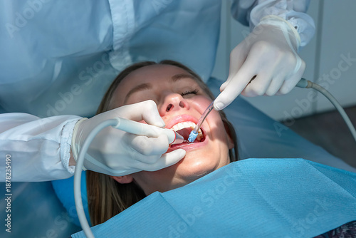 Photos Dentist performing professional dental cleaning using an ultrasonic scaler