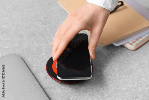 Woman putting modern mobile...
