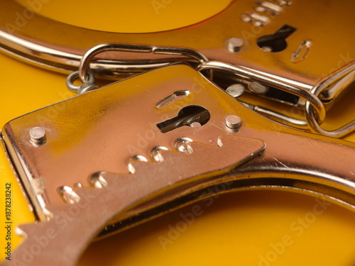 This image displays a close-up of a pair of metal handcuffs
