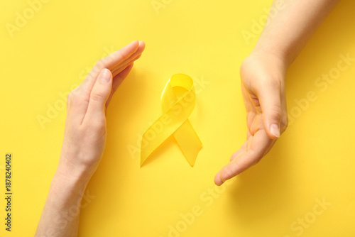 Female hands and yellow rib...