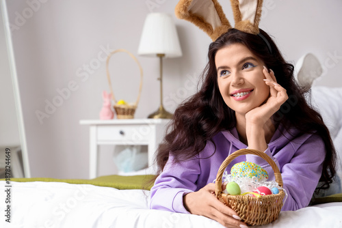 Young woman in bunny ears w...