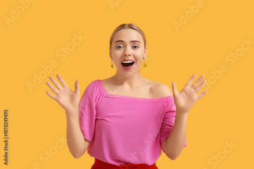 Happy young woman on orange...