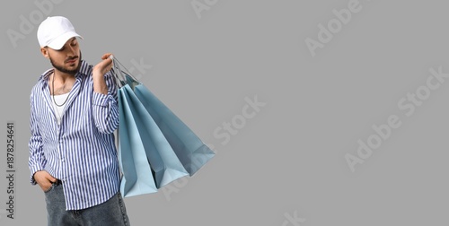 Stylish young man with shop...