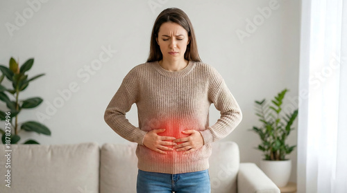 Caucasian woman suddenly experiencing severe stomach ache in living room